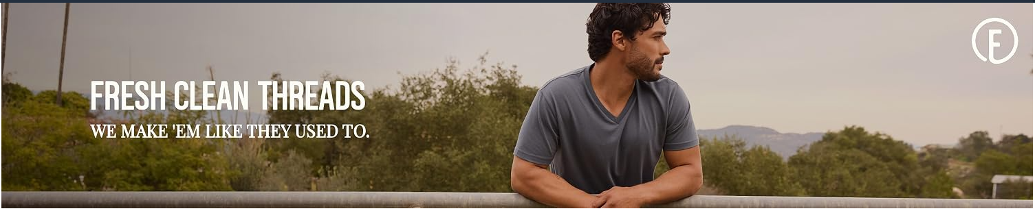 Fresh Clean Threads banner showing a man wearing a gray V-neck T-shirt outdoors.